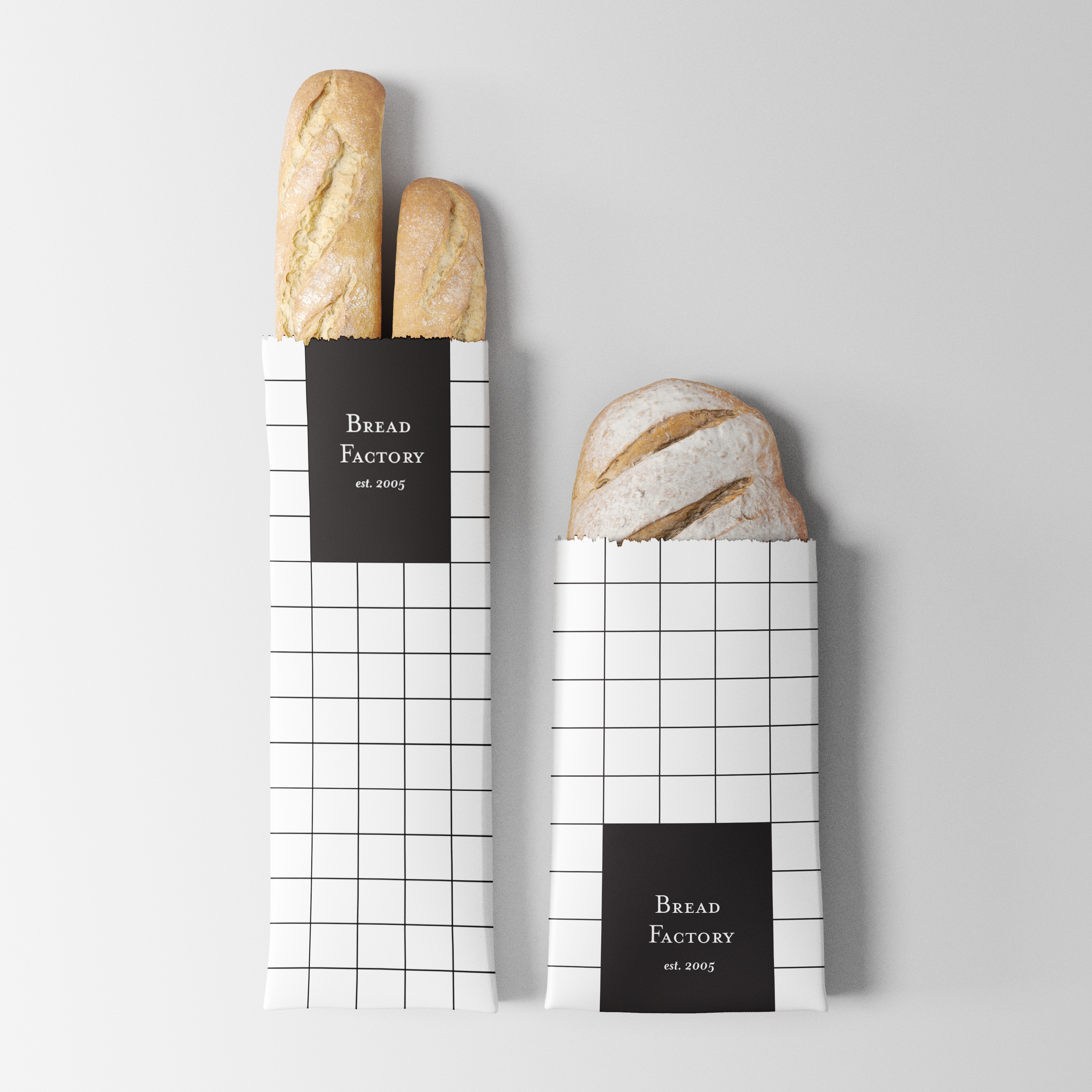 2 loaves of bread in white and black minimal packaging. There is a pattern that resembles tile and the packaging reads 'Bread Factory'.